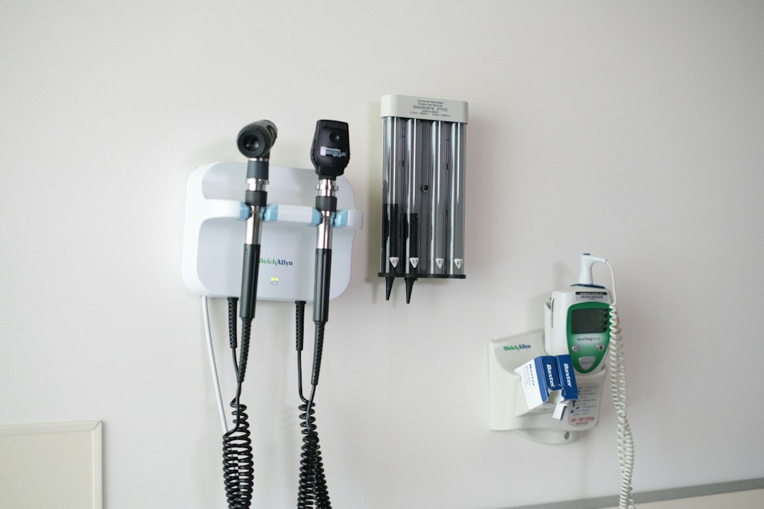 Diagnostic instruments mounted on the wall of an examination room.